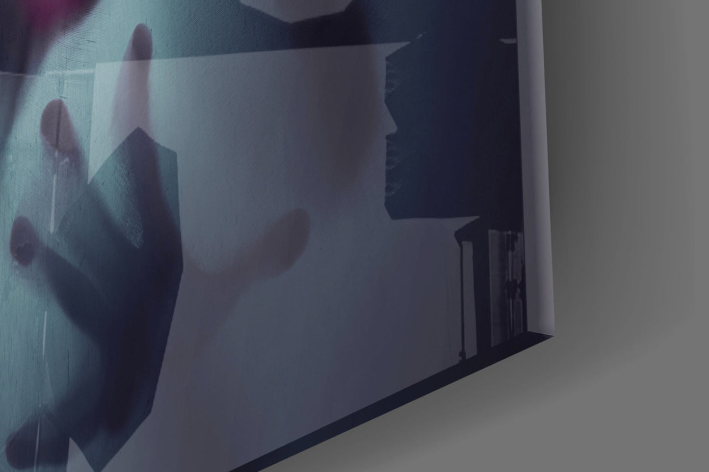 Frosted glass wall art displaying silhouetted figures in muted tones, mounted at an angled perspective showing depth and translucency.