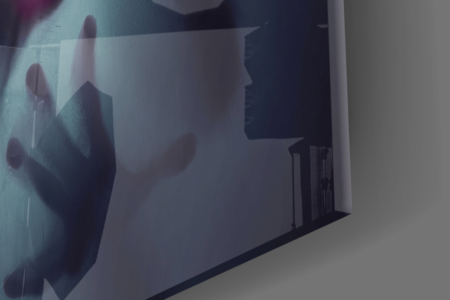 Frosted glass wall art displaying silhouetted figures in muted tones, mounted at an angled perspective showing depth and translucency.