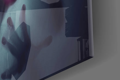 Frosted glass wall art displaying silhouetted figures in muted tones, mounted at an angled perspective showing depth and translucency.