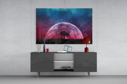 Mystical Night Glass Wall Art displayed on a gray media console, showing a pink moon with silhouetted tree and starry sky backdrop.