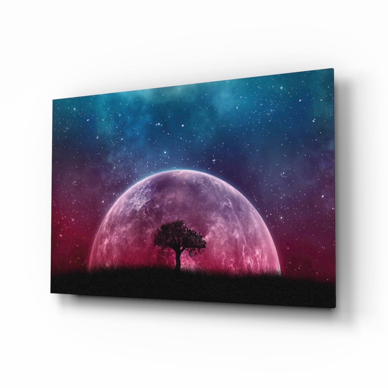Glass wall art panel displaying a silhouetted tree against a large pink moon with starry gradient sky, angled perspective view.