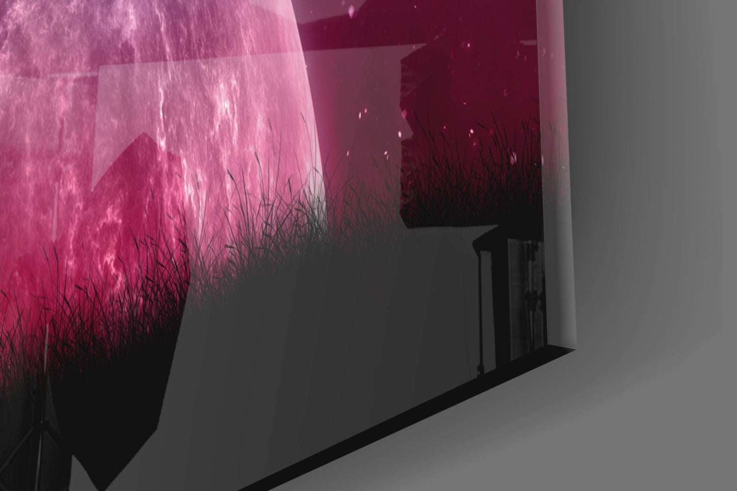 Illuminated glass wall art panel displaying magenta and black gradient with silhouetted grass texture, installed in corner space.