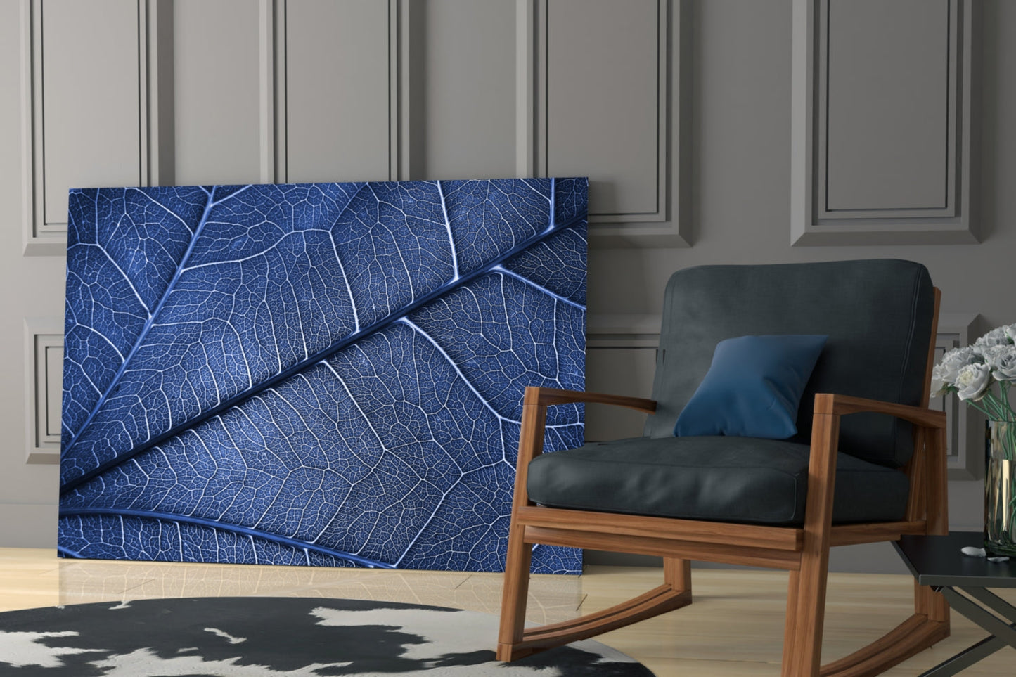 Macro Blue Leaf Glass Wall Art displayed on a wall behind a wooden chair with black leather cushioning in a modern interior setting.
