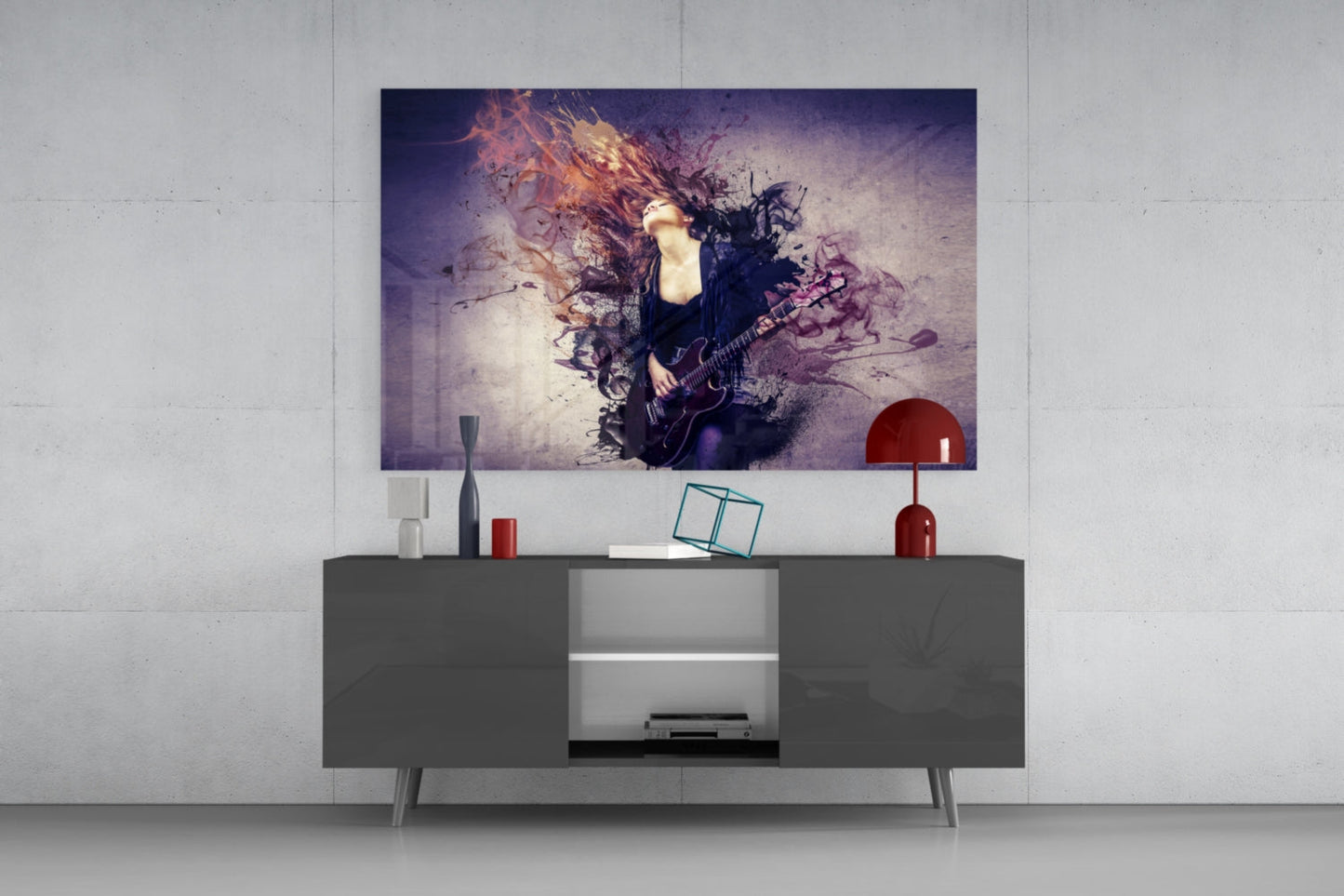 Rock glass wall art featuring musician with guitar amid purple and orange paint splatter effects, displayed above gray media console in modern living room setting.