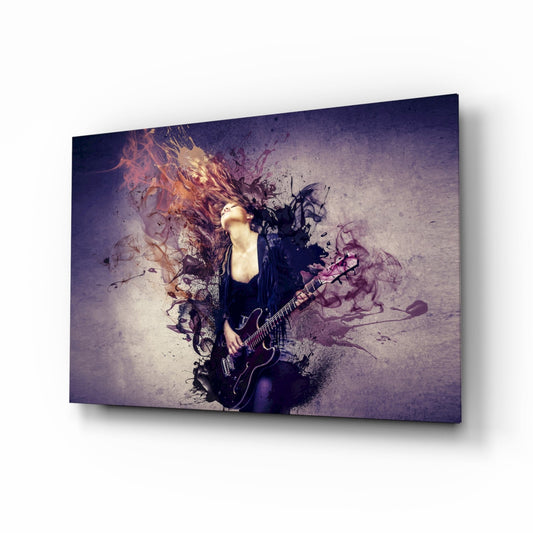 A woman with long dark hair plays electric guitar, surrounded by purple and orange paint splatter effects on a textured gray background on a glass wall panel.