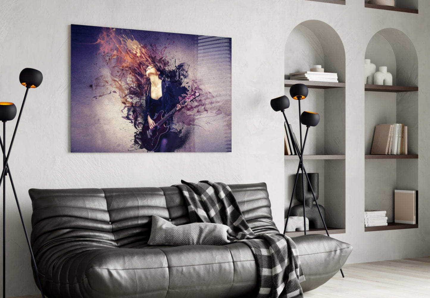 Rock Glass Wall Art depicting a musician with electric guitar amid purple and orange abstract splatter effects, hung above a dark leather sofa in a modern living room.