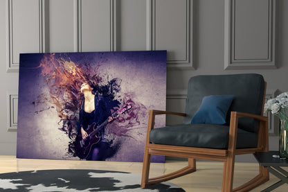 Rock Glass Wall Art displaying a female guitarist with purple and orange explosive effects, displayed in a modern living room next to a wooden chair.