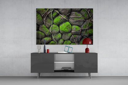 Mossy Stones Glass Wall Art displayed above a gray media console with red decorative accessories in a modern living room setting.