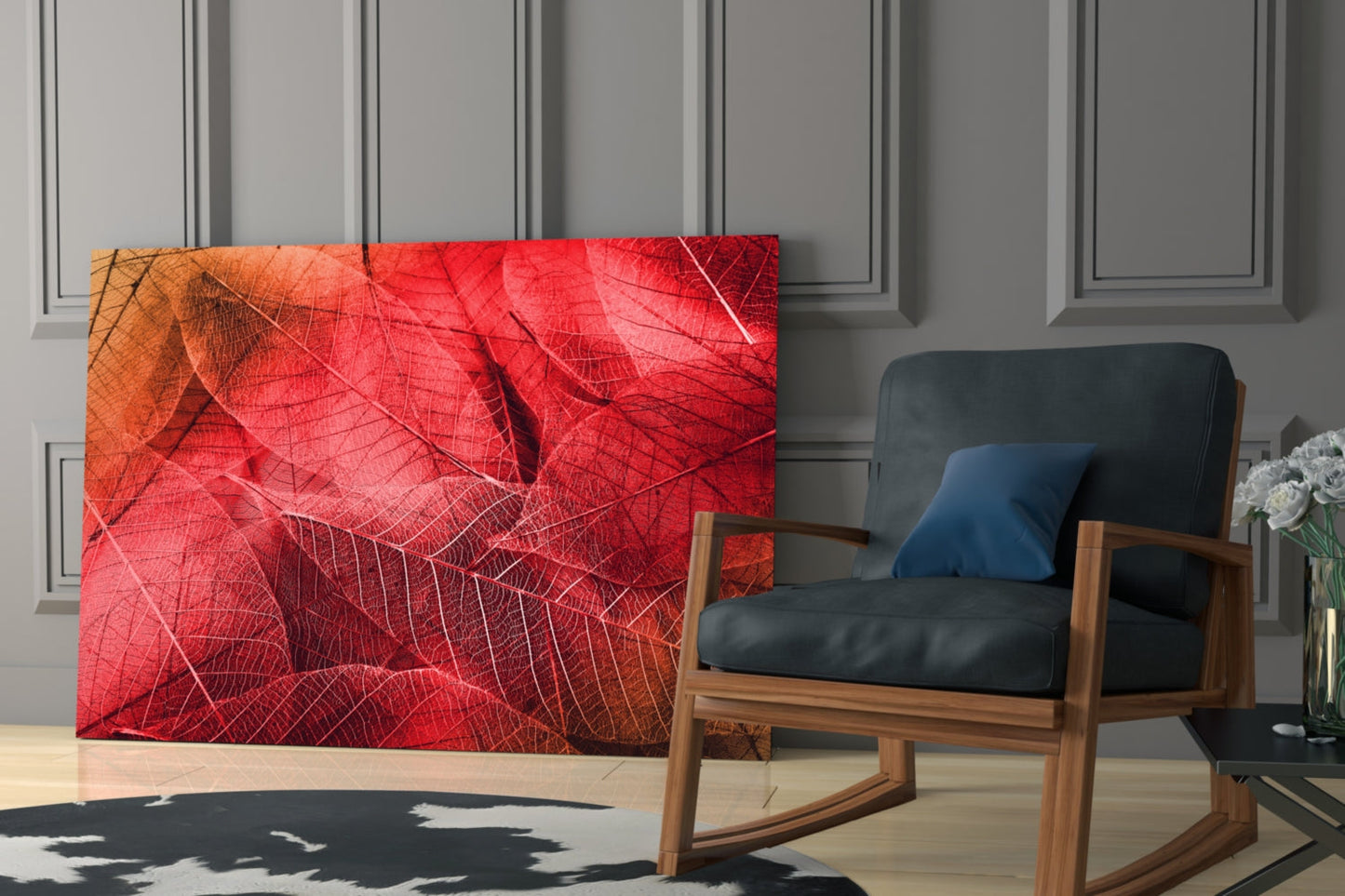 Red and orange macro leaf glass wall art displayed in modern living room beside wooden chair with black leather cushion.