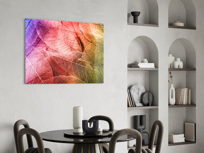 Colorful glass wall art with gradient leaf vein patterns in purple, pink, orange, and yellow hung above a black round dining table.