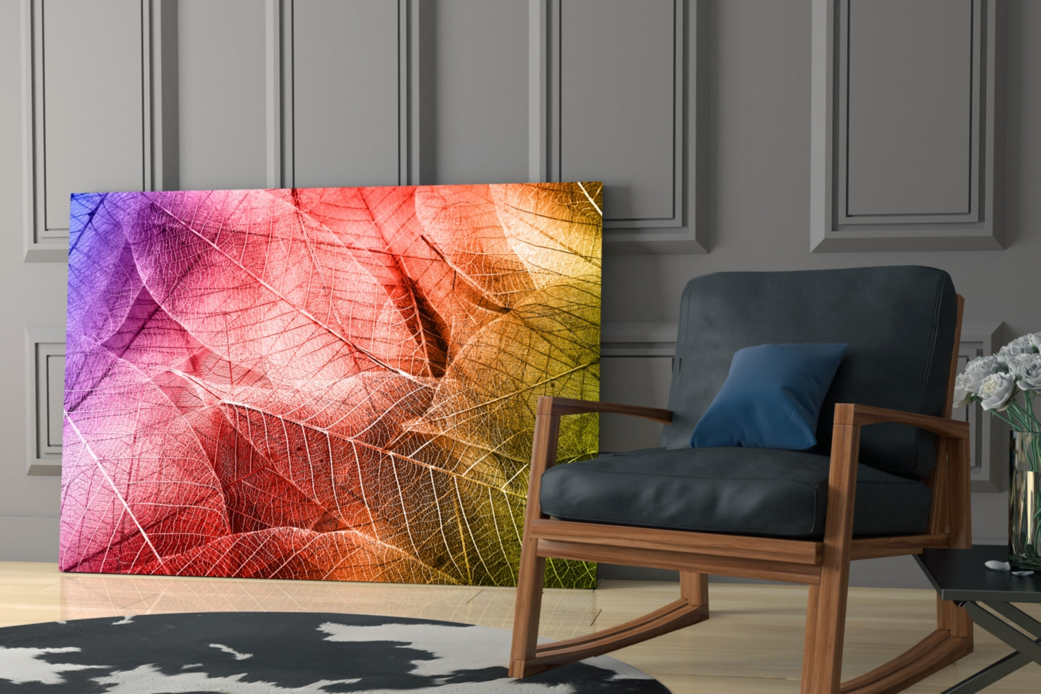 Colorful glass wall art featuring gradient leaves in purple, pink, red, orange, and yellow displayed in a modern room setting.