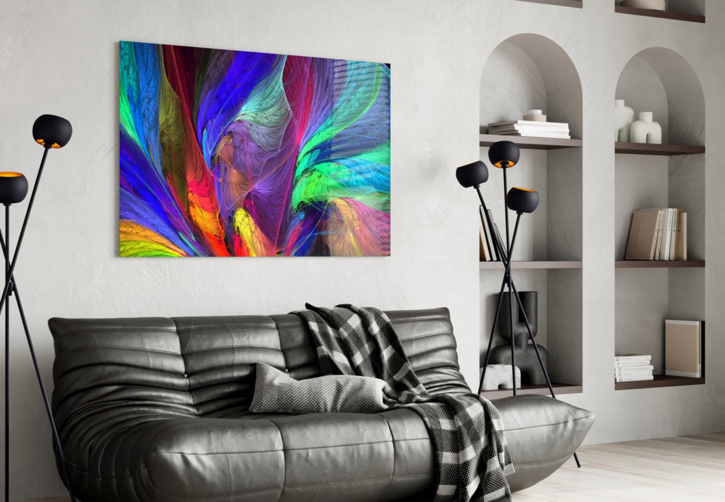 Vibrant abstract glass art with swirling blue, green, pink, and yellow patterns displayed above a black leather sofa in a modern living room.