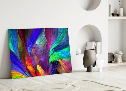 Vibrant multicolored glass art panel with swirling blue, green, red, and yellow patterns leaning against white interior wall.