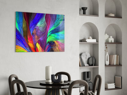 Vibrant multicolored abstract glass art displaying swirling patterns in blue, green, red, and yellow mounted above a black dining table.
