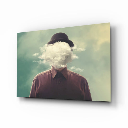 Man wearing burgundy shirt and bowler hat with cloud replacing head, displayed on angled glass panel against soft green sky background.
