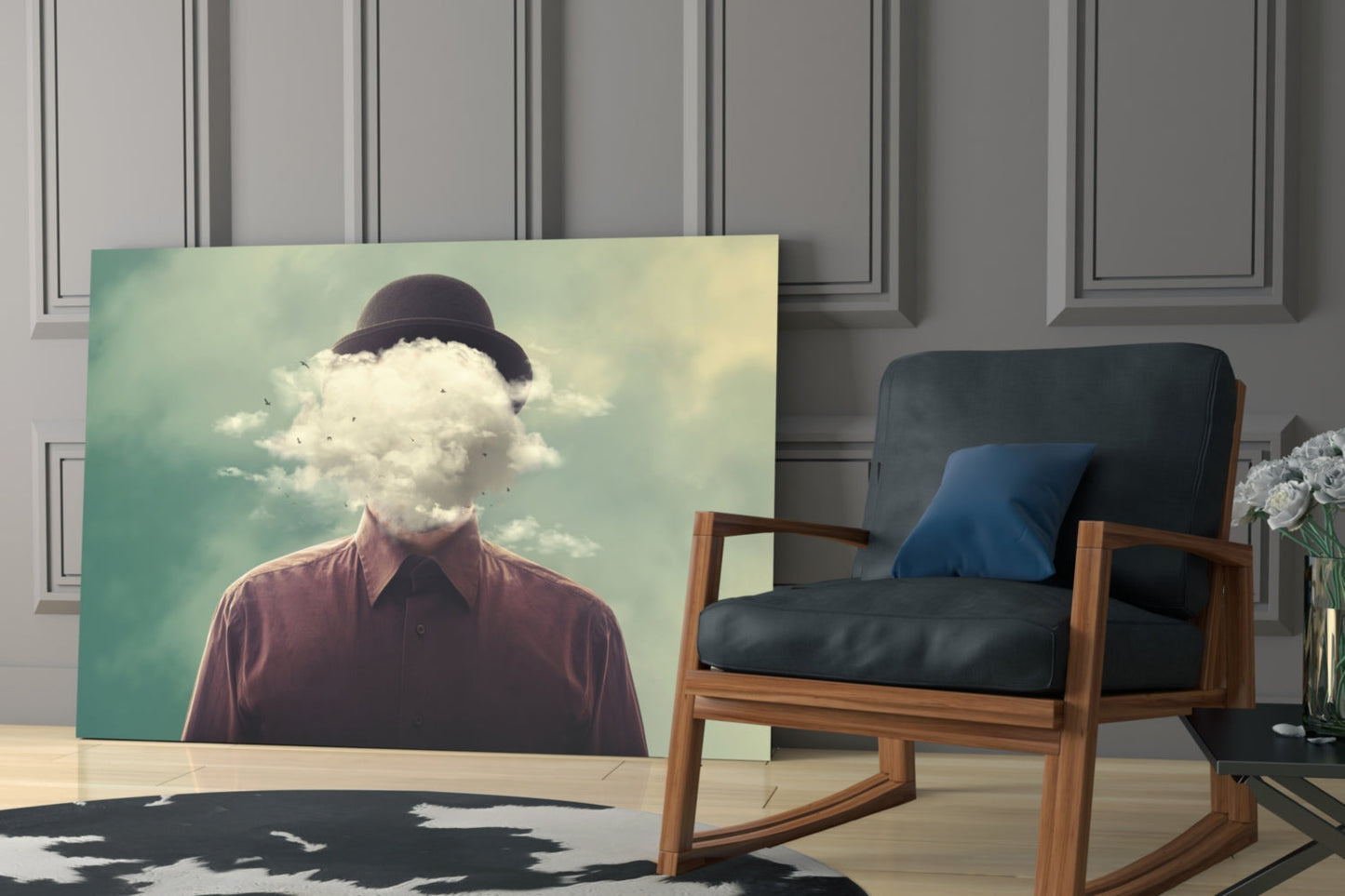 Surreal glass artwork displayed in modern interior shows man with bowler hat and cloud replacing his head against turquoise sky.
