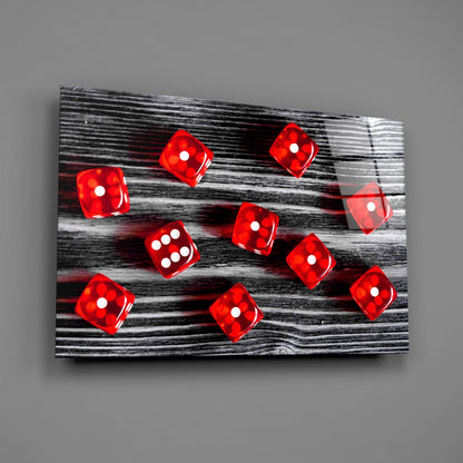Red translucent dice with white dots scattered on black and white wood grain glass panel, angled perspective view.
