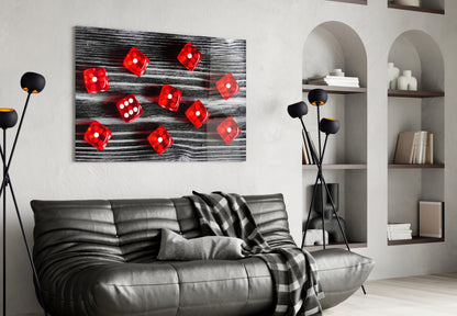 Red dice glass wall art displayed above black leather sofa in modern living room with white shelving.