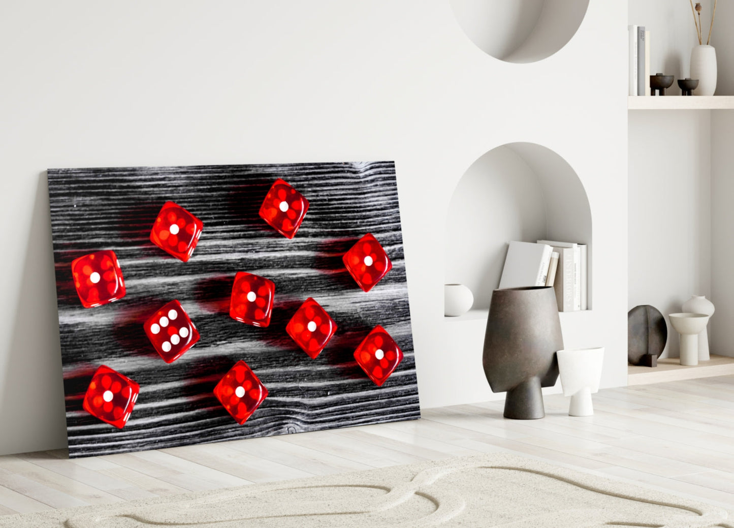 Red dice with white dots on dark wood grain background glass panel leaning against white wall.