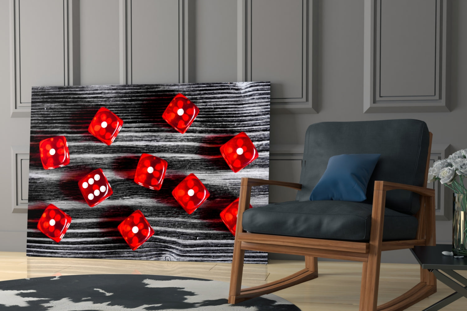 Red dice with white dots displayed on black and white wood-textured glass art leaning against modern interior wall.