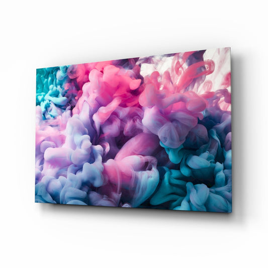 Angled perspective of glass wall art displaying swirling pink, purple, and teal ink clouds against white, mounted on light background.