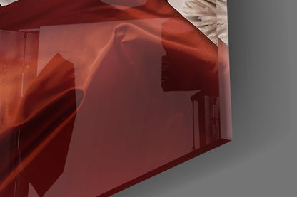 Red translucent glass wall art panel showing silhouetted female profile against interior room background, angled product shot.