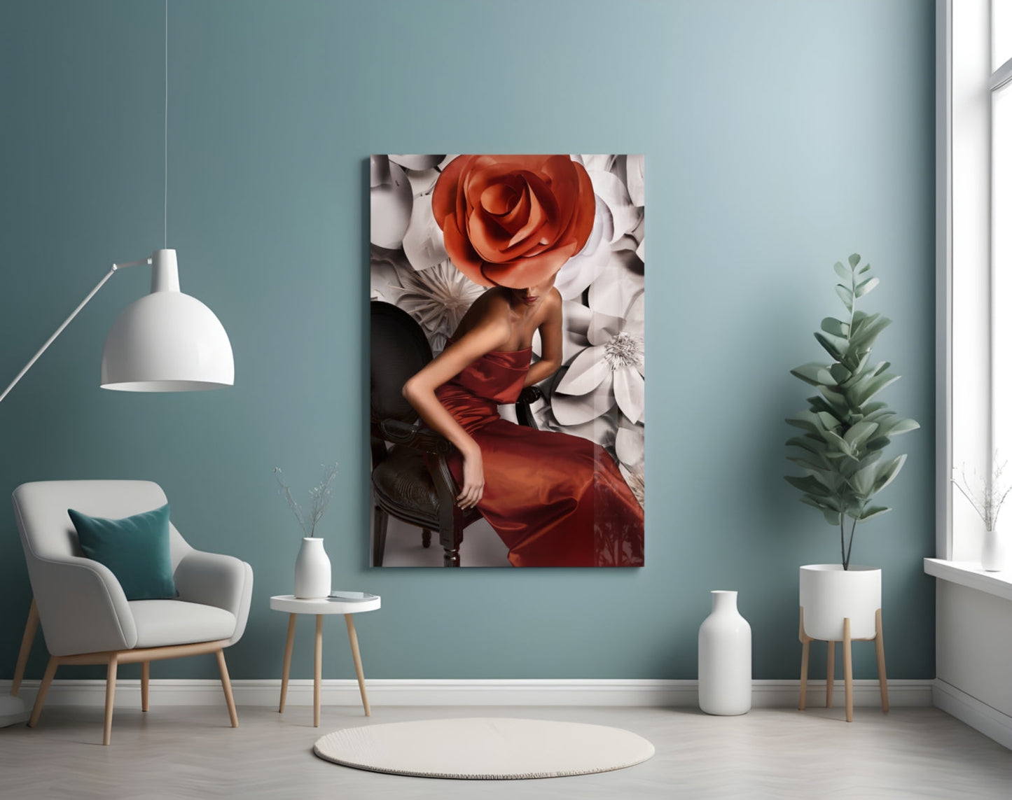 Glass wall art depicting a woman in a red dress with a large red rose for a head, displayed in a modern teal room setting.