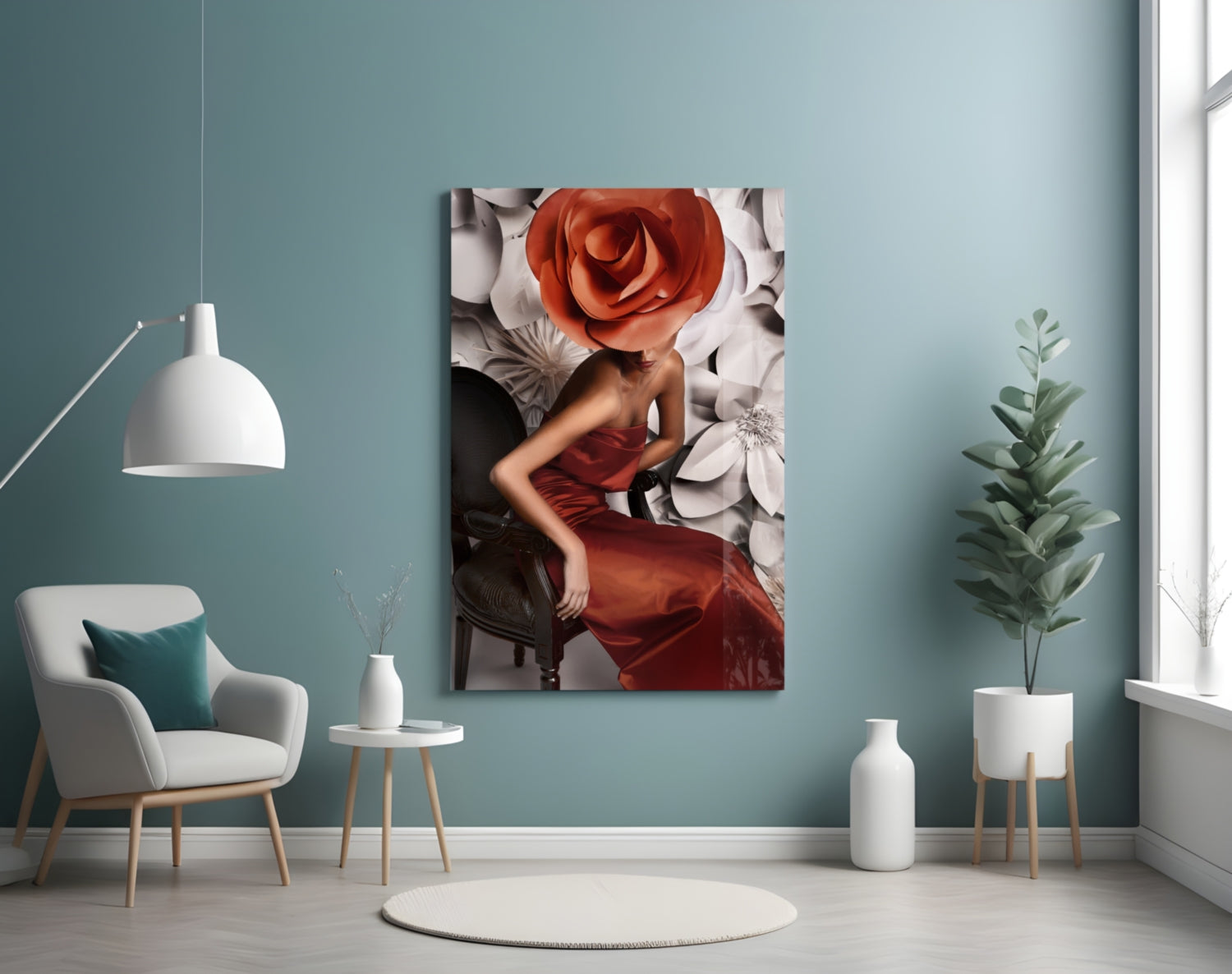 Glass wall art depicting a woman in a red dress with a large red rose for a head, displayed in a modern teal room setting.