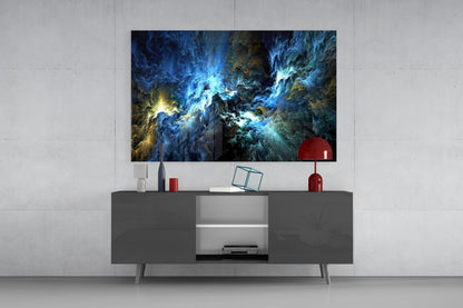 Cosmic Blue Glass Wall Art displaying swirling blue and gold nebula patterns mounted above a gray media console with red decorative accessories.