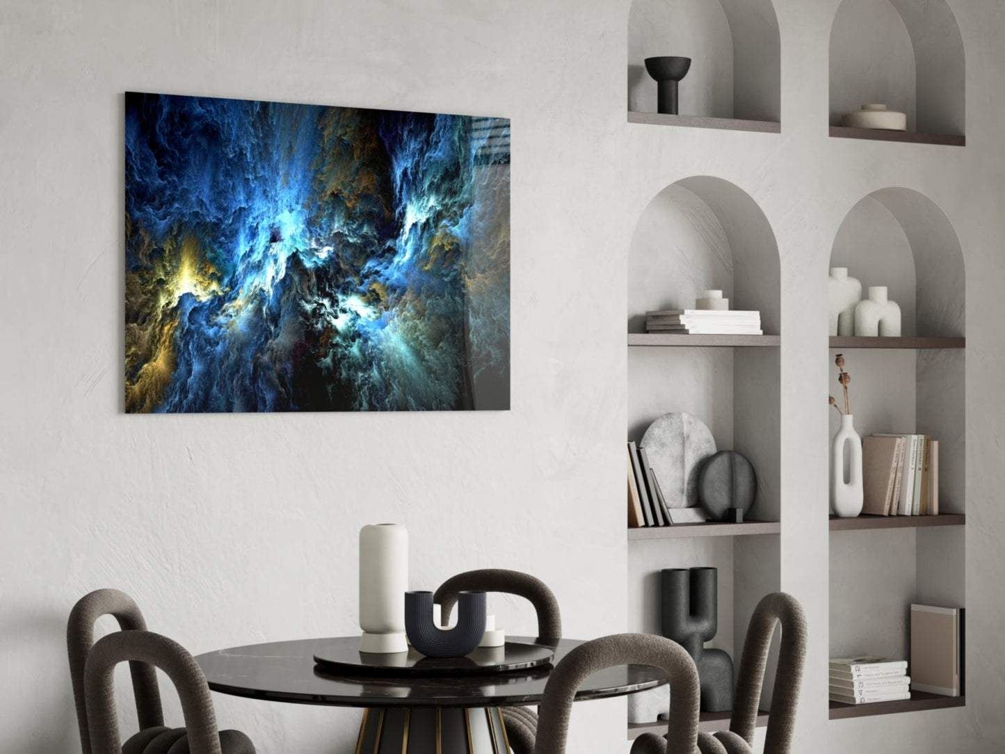 Cosmic Blue glass wall art displaying swirling blue and gold nebula patterns hung above a black dining table in a modern interior setting.