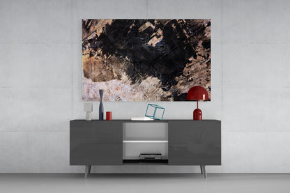 Modern living room setup with abstract textured glass art featuring black, tan, and white tones displayed above gray media console with red decorative accessories.