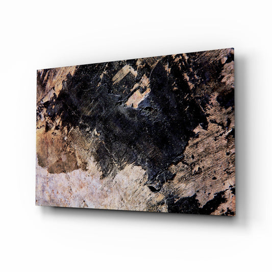 Angled perspective of glass wall art displaying textured abstract pattern with black, brown, and cream tones resembling weathered stone or rust.