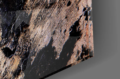 Close-up detail of textured glass surface with brown, tan, and black layered patterns and relief features.
