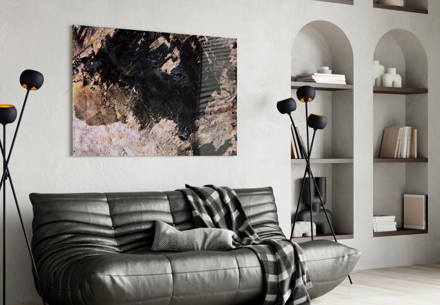 Abstract textured glass wall art with black, tan, and cream tones displayed above a black leather sofa in a modern living room.