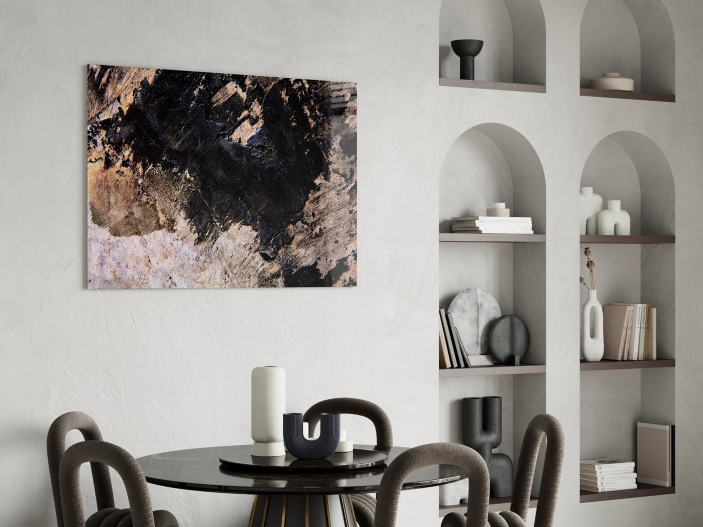 Abstract wall art with black, tan, and cream textured surface hanging above a black round dining table with gray upholstered chairs.