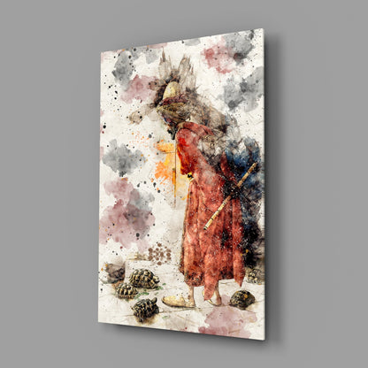 Angled view of glass wall art featuring a watercolor illustration of a figure in red robes with a bird head, surrounded by tortoises and abstract watercolor splashes in gray, pink, and black tones.