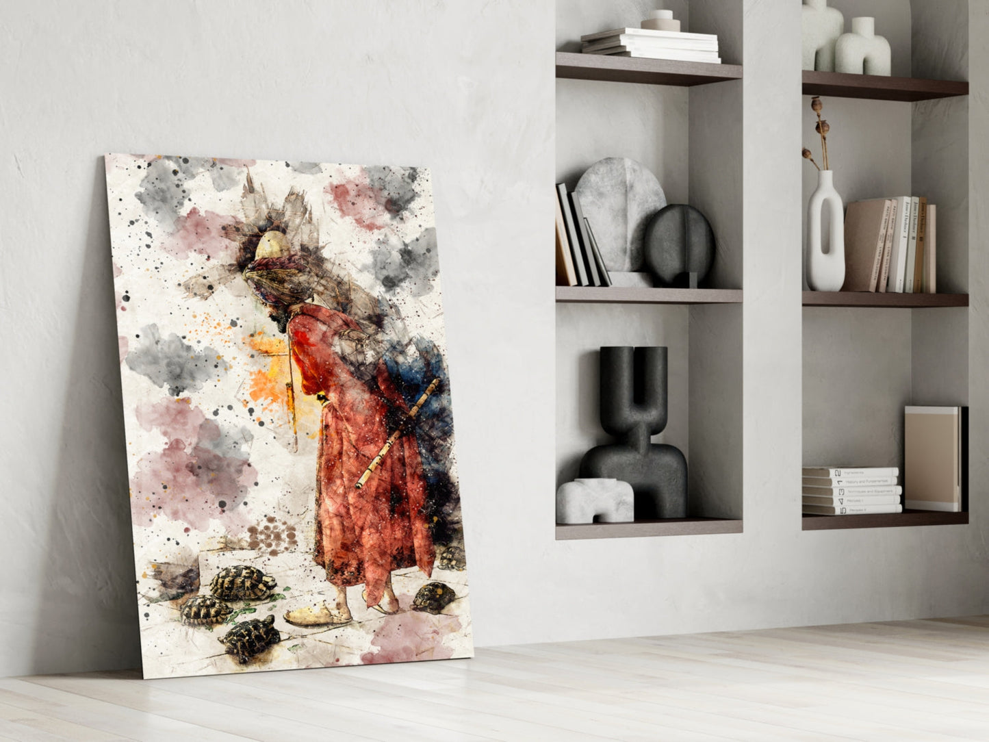 Watercolor glass art leaning against white wall displaying woman in red dress with tortoises, displayed beside built-in shelving with decorative objects and books.