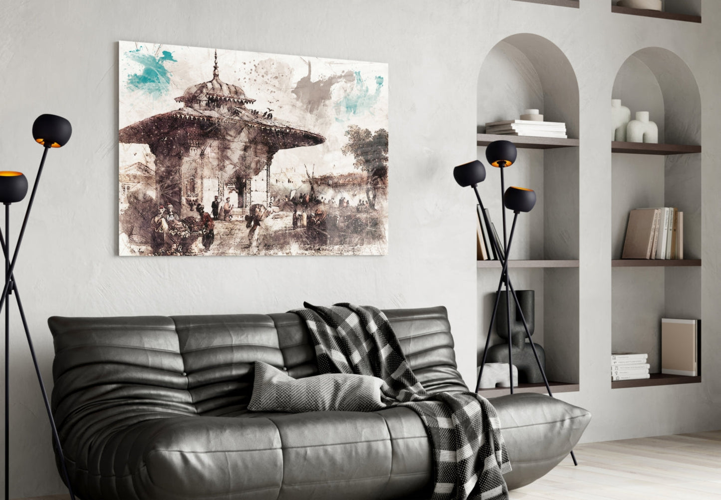 Horizontal glass wall art depicting sepia-toned Ottoman architectural illustration above black leather sofa in minimalist interior.