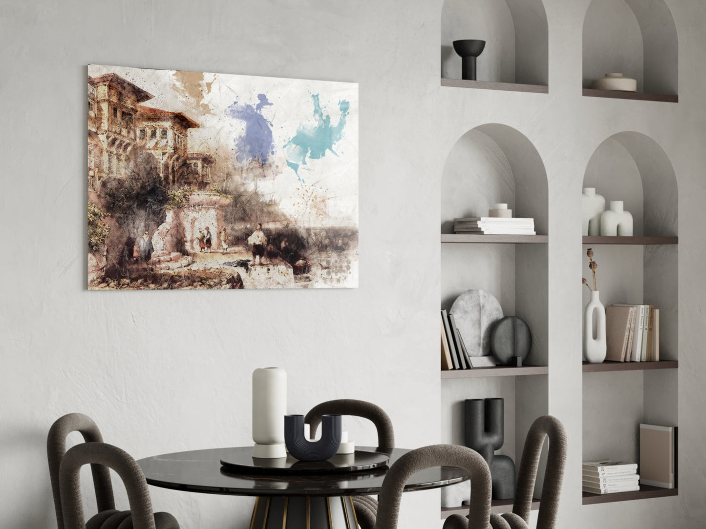 Watercolor architectural artwork featuring a historic building with blue and teal map splashes displayed above a black dining table in a modern interior setting.