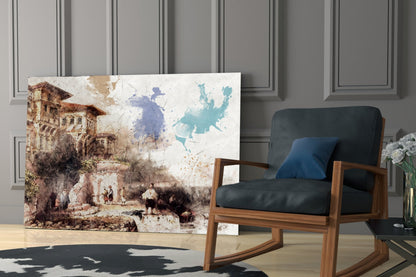 Glass wall art depicting a sepia-toned European castle with watercolor map overlay in blue and teal tones, displayed in modern living room setting.