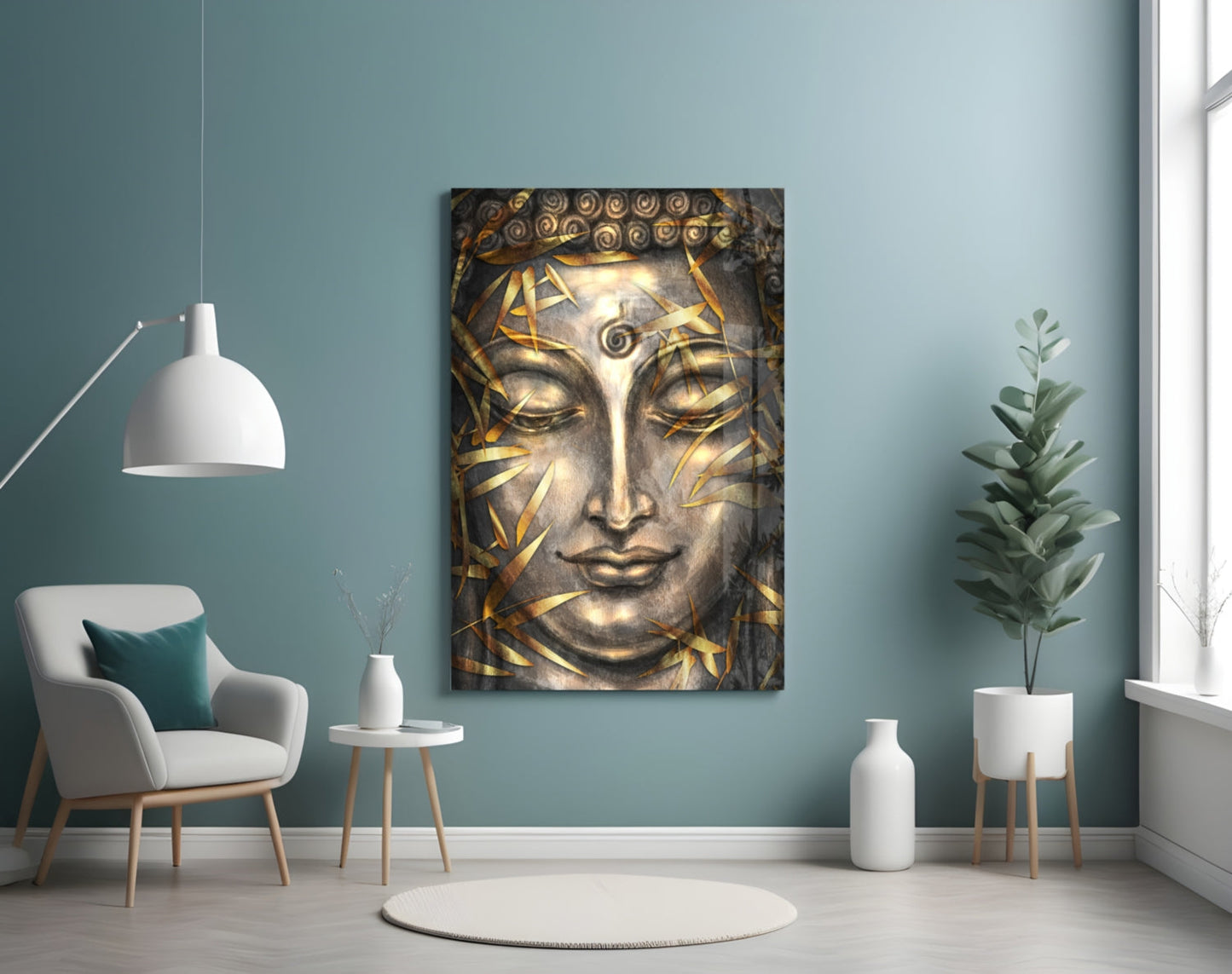 Buddha head glass wall art with gold leaf details displayed in a serene teal room with chair and plants.