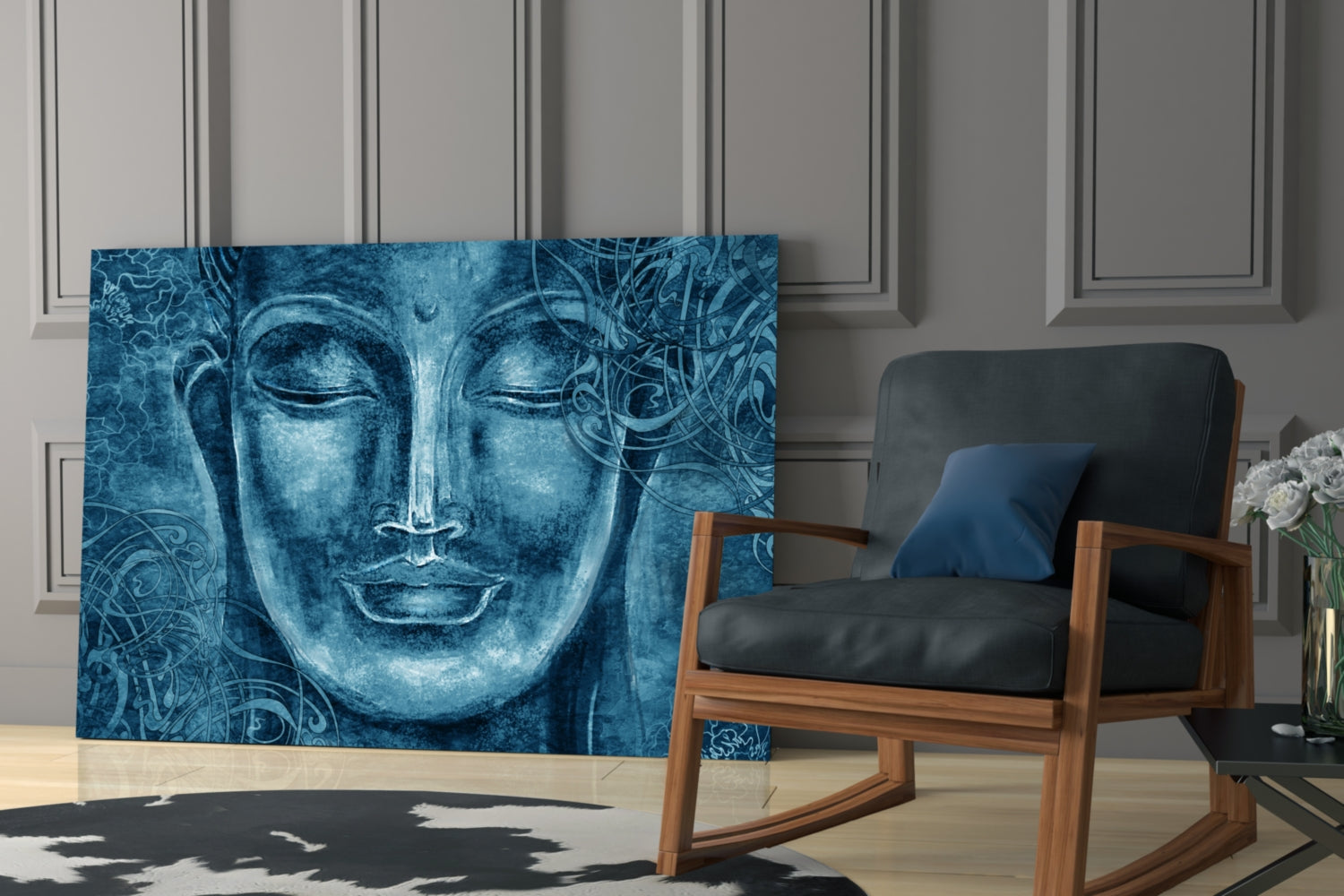 Blue glass wall art featuring a serene Buddha face with ornamental patterns, displayed in a modern living room beside a wooden chair.