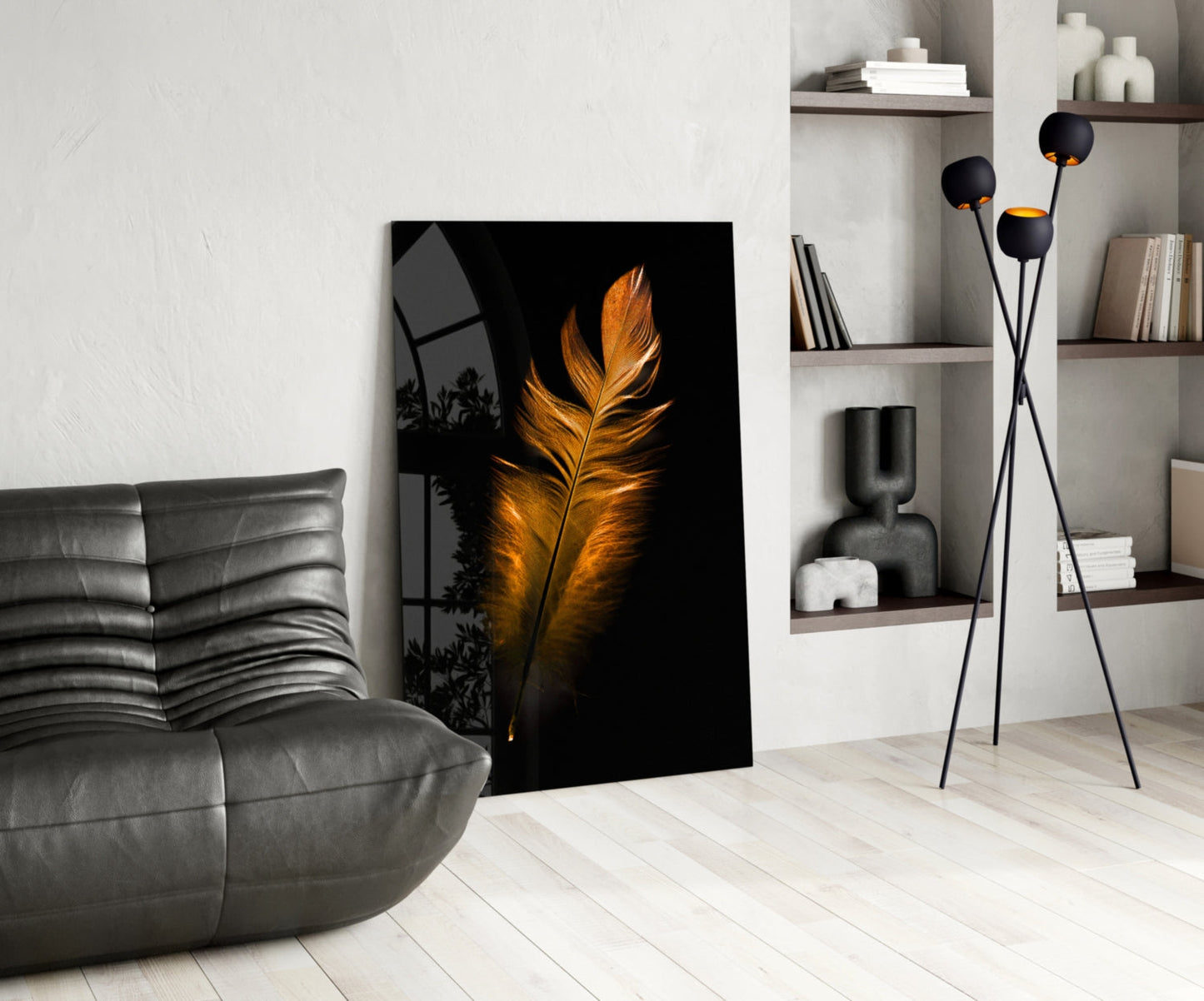 Copper Feather Glass Wall Art leaning against white wall in modern living room with gray sofa and shelving.