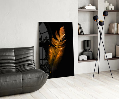 Copper Feather Glass Wall Art leaning against white wall in modern living room with gray sofa and shelving.