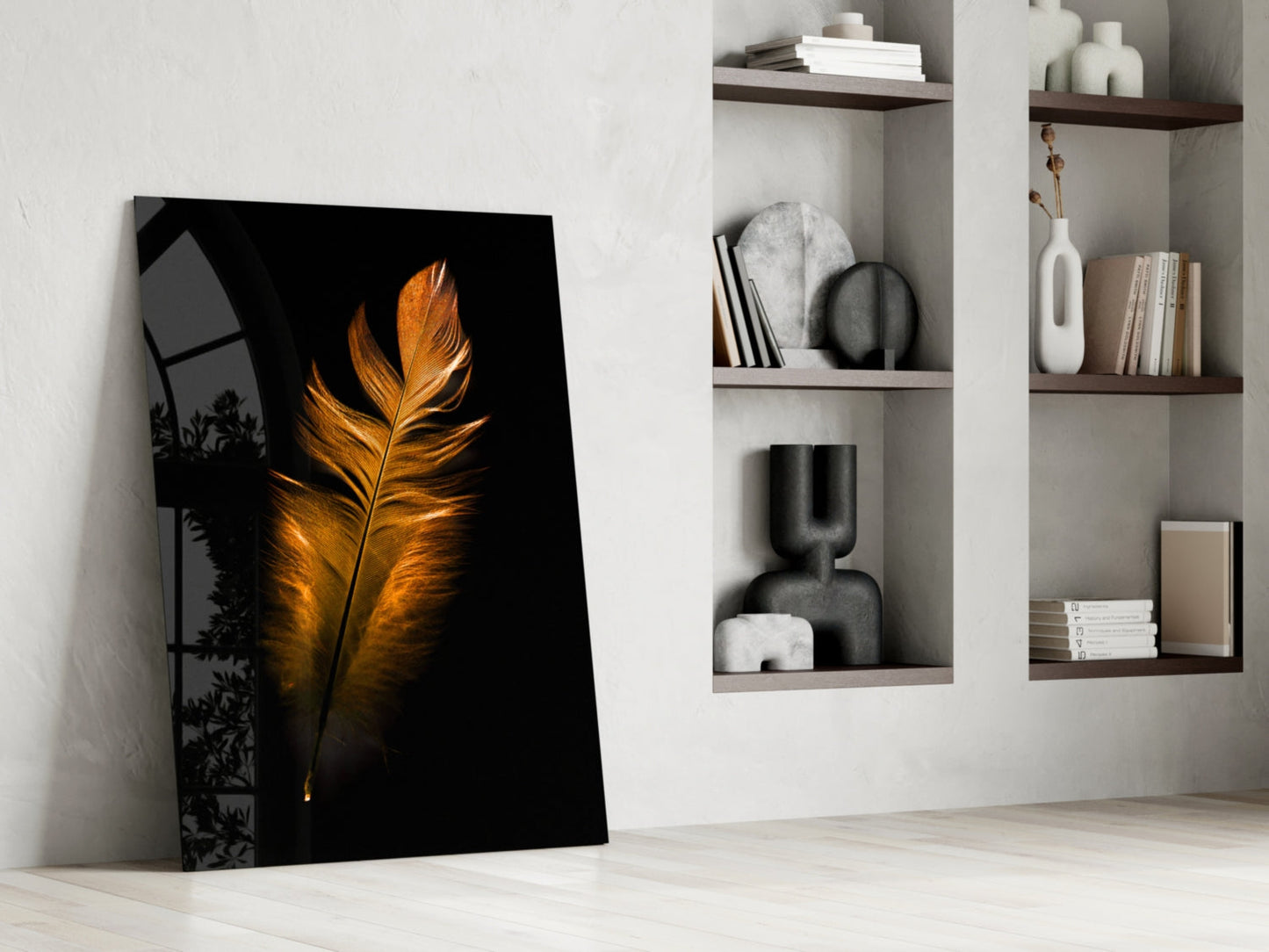 Copper Feather Glass Wall Art leaning against white wall beside shelving units displaying books and decorative objects.