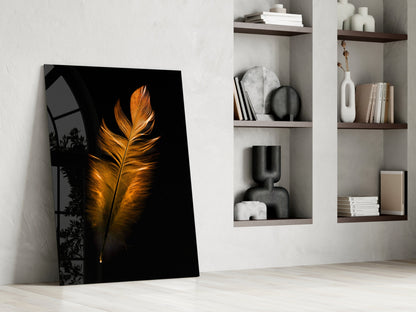 Copper Feather Glass Wall Art leaning against white wall beside shelving units displaying books and decorative objects.