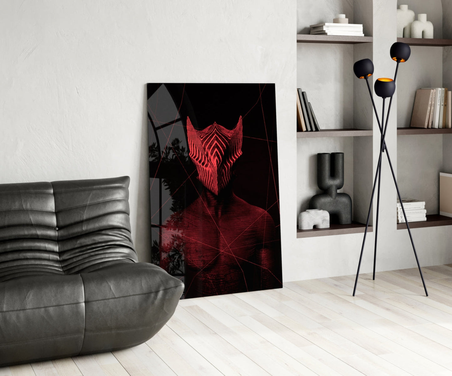 Red neon glowing mask artwork displayed in modern living room with gray leather sofa, shelving, and floor lamp.