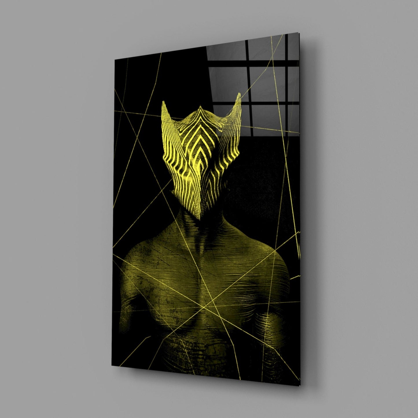 Glass wall art displaying a stylized yellow bearded face on black background with geometric gold line overlay, angled perspective view.