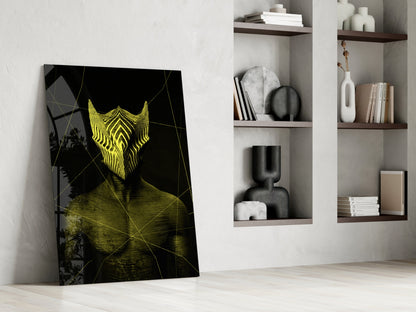 Darko Yellow Glass Wall Art leaning against white wall beside shelving unit, displaying yellow neon mask design on black background.