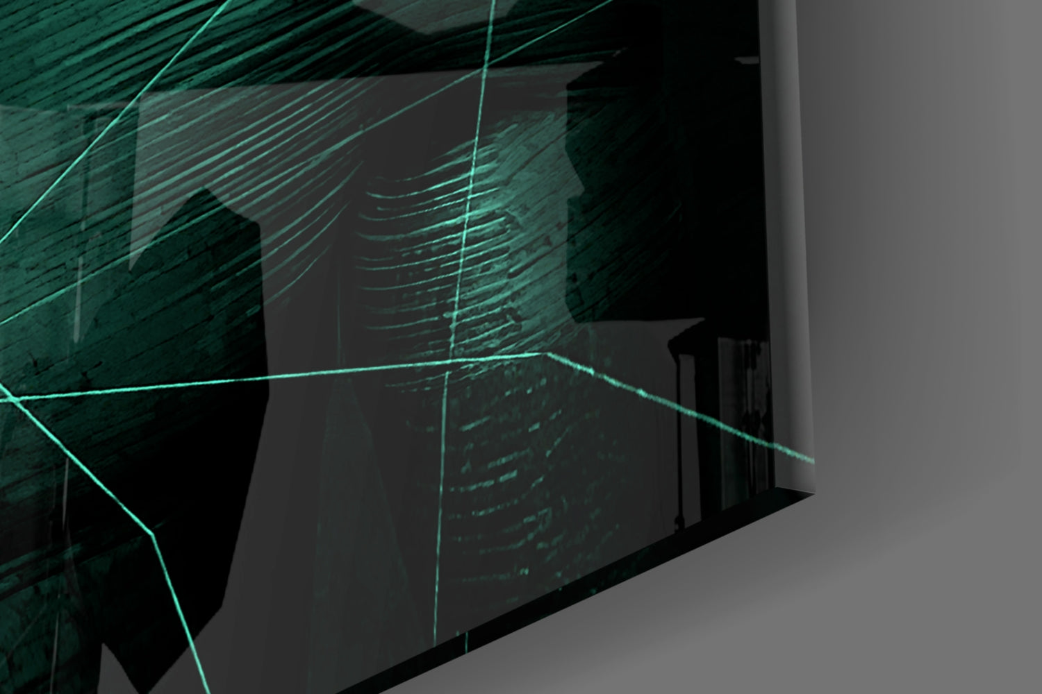 Angled view of emerald green glass wall art with glowing cyan linear patterns mounted on light gray wall.